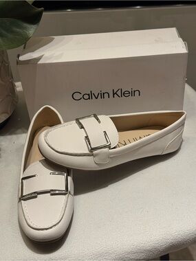 Calvin Klein Lydia Loafer in white, highlighted by a metallic rectangular buckle